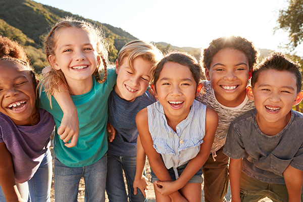 Six multiracial kids smiling